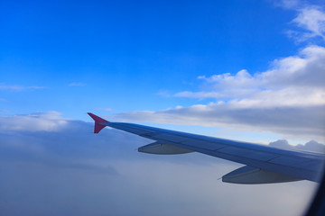 Fototapeta na wymiar Beautiful view through Passenger plane window above the clouds