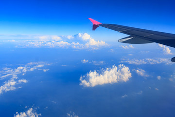 Fototapeta premium Beautiful view through Passenger plane window above the clouds