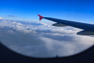 Fototapeta premium Beautiful view through Passenger plane window above the clouds