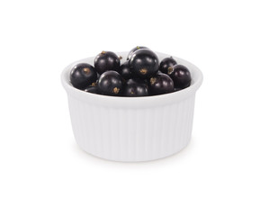 Bowl with blackcurrants isolated on white background. Ripe currants close-up. Background berry. Sweet and juicy berry with copy space for text. Antioxidant and the best berry, a source of vitamin C