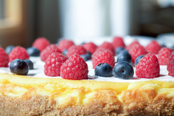 close up of  berries as decoration of a cheese cake