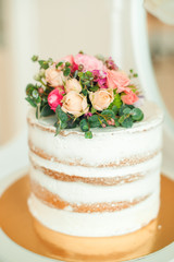 Decorated white naked cake rustic style for weddings, birthdays and events.