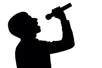 Fototapeta na wymiar Silhouette of a man singing into a microphone