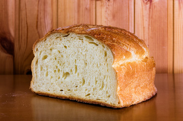 Fresh bread slice on wooden table. Selective focus