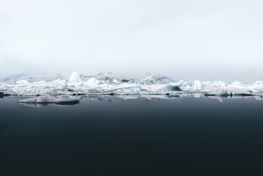 View of iceberg in sea against sky