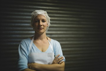 Female beekeeper wearing protective headdress at factory