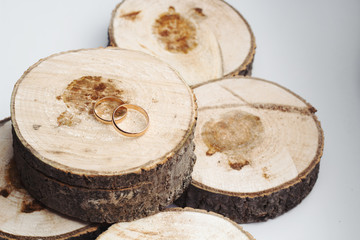 wedding golden rings on wooden stumps.top view.