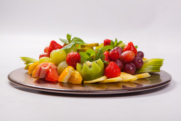 Mixed Fruit platter with assorted fruits on a white background