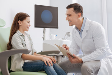 Positive delighted medical worker making some notes