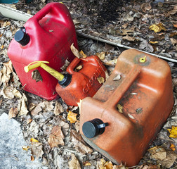 Got gas? Above view of three well-used gas containers on ground.