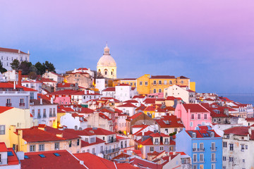 Scenic view of Alfama, the oldest district of the Old Town, with National Pantheon at pink sunset, Lisbon, Portugal