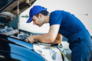 Mechanic fixing a car engine