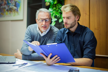 Businessman showing a document to his colleague