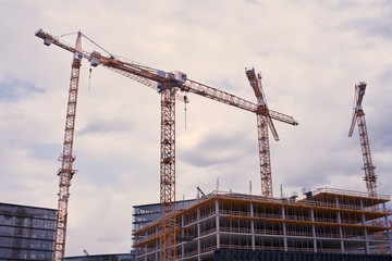 Fototapeta na wymiar Modern housing development with cranes