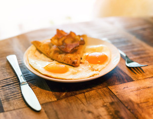 American breakfast with fried egg and becon