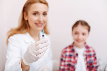 Close up of syringe being in female hand