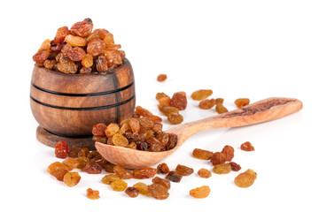 raisins in a wooden bowl with spoon isolated on white background