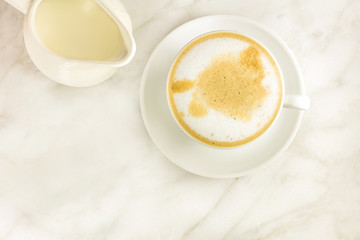 Cup of coffee with milk jar and copyspace