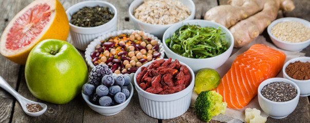 Selection of superfoods on rustic background