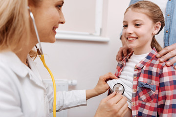 Portrait of smiling little patient looking at her doctor