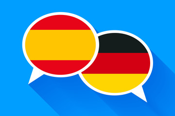 Obraz premium Two white speech bubbles with Spain and German flags.