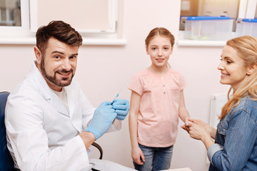 Positive delighted doctor smiling on camera