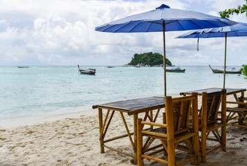 Chair with umbrella are on the beach