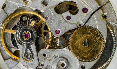 Macro of the pendulum and gears of the old watch