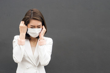 Woman suffer from sick and wearing face mask., asian woman in protective mask feeling bad on the street in the city with air pollution. with copy space for text.