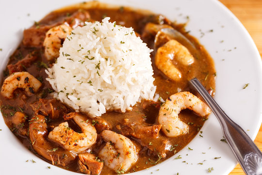 Seafood Gumbo with Mound of White Rice in a white blow with spoon
