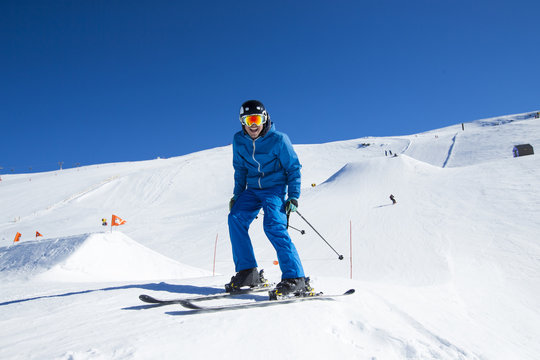 Men skier smiling at camera.