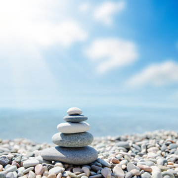 zen-like stones on beach under sun