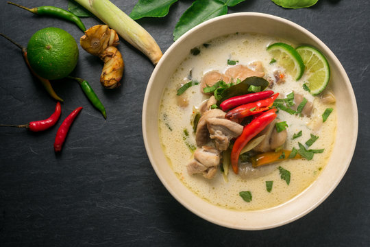 Chicken coconut soup (Tom Kha Gai), Thai food on black stone table background
