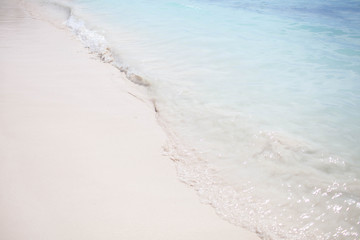 a wave of blue and white sand