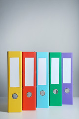 Colorful office folders on grey background