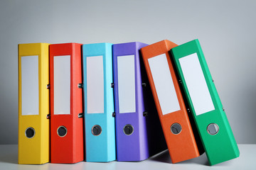 Colorful office folders on grey background
