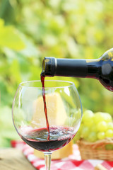 Pouring red wine into the glass