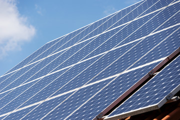 Alternative energy photovoltaic solar panels on roof of residential house