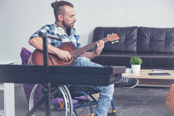 Capable handicap playing musical instrument in the studio