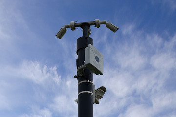 CCTV cameras in field , blue sky background.