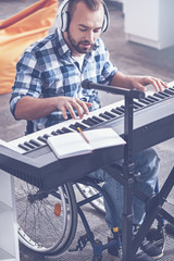 Enthusiastic disabled playing musical instrument in the recording studio