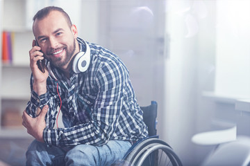 Happy handicap enjoying conversation on the phone at home