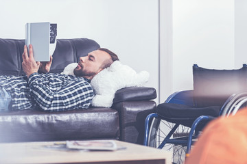 Intelligent young disabled relaxing at home