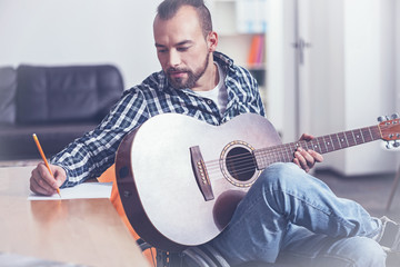 Lively mature handicap writing a song at home