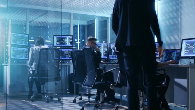Time-Lapse Footage of Government System Control Center Full of Professional. They Work at Their Workstations and Interact With Each Other. Room Has Multiple Displays with Data Shown on Screens. 
