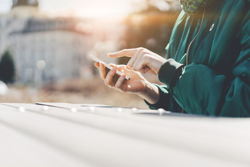 Girl pointing finger on screen smart phone on background city, Blogger texting message on smart phone, Searching or social networks concept.