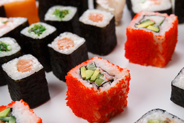 Set of sushi, maki and rolls isolated closeup with chopsticks