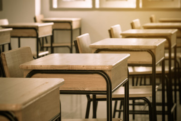 School classroom with desks chair wood, and blackboard in high school thailand, vintage tone education concept