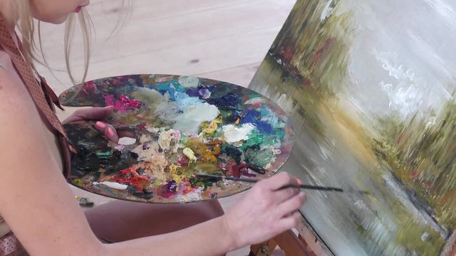 Mixing paint on palette, close-up