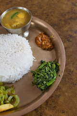 Dalh Bhat, a staple Nepali food served on a table. Image take from above.